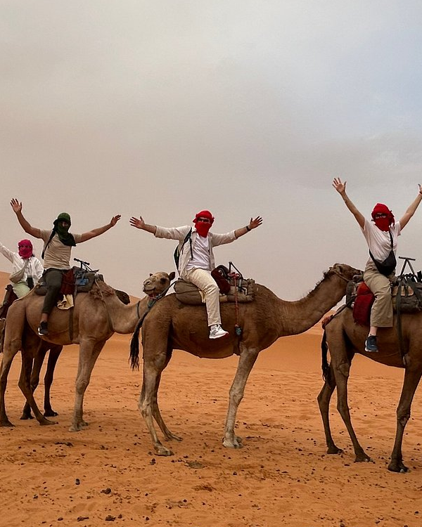 People in the desert on camels