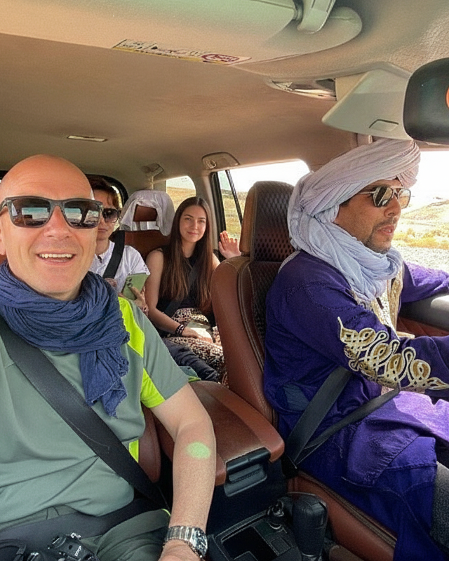 A group of people with a Berber driving